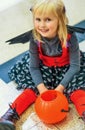 Child with Halloween pumpkin Jack OÃ¢â¬â¢Lantern basket sitting Royalty Free Stock Photo